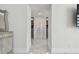 Hallway view towards a large closet with shelving and marble walls at 1560 Gulf Blvd # 306, Clearwater Beach, FL 33767
