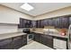 A kitchen with stainless steel appliances and dark wood cabinets at 1560 Gulf Blvd # 306, Clearwater Beach, FL 33767