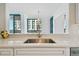 Kitchen sink view looking out to the living room and exterior views at 1560 Gulf Blvd # 306, Clearwater Beach, FL 33767