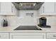 Modern kitchen cooktop featuring sleek appliances and quartz countertops at 1560 Gulf Blvd # 306, Clearwater Beach, FL 33767