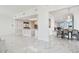 Bright open-concept living and kitchen area with marble floors and modern design elements at 1560 Gulf Blvd # 306, Clearwater Beach, FL 33767