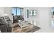 Bright living room featuring tile floors, neutral decor, and large windows with ocean views at 1560 Gulf Blvd # 306, Clearwater Beach, FL 33767