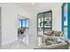Bright and airy living space featuring comfortable seating and large windows with ocean views at 1560 Gulf Blvd # 306, Clearwater Beach, FL 33767