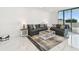 Comfortable living room features modern furnishings and access to the outdoor balcony at 1560 Gulf Blvd # 306, Clearwater Beach, FL 33767
