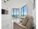 Bright living room with large windows showcasing ocean views and comfortable seating at 1560 Gulf Blvd # 306, Clearwater Beach, FL 33767