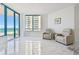 Well-lit living room offering floor to ceiling windows with views of the ocean at 1560 Gulf Blvd # 306, Clearwater Beach, FL 33767