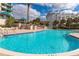 Resort-style pool with beautiful, lush landscaping and seating areas; ideal for relaxation and community engagement at 1560 Gulf Blvd # 306, Clearwater Beach, FL 33767
