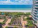 Aerial view of the rooftop patio overlooking the ocean and beach with resort buildings in the background at 1560 Gulf Blvd # 306, Clearwater Beach, FL 33767
