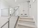 Marble staircase with glass railings leading to the upper level at 1560 Gulf Blvd # 306, Clearwater Beach, FL 33767