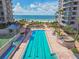 Outdoor swimming pool with ocean views and resort buildings, perfect for relaxation and recreation at 1560 Gulf Blvd # 306, Clearwater Beach, FL 33767