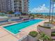 Beautiful outdoor pool overlooking the ocean, with resort buildings adding to the picturesque scene at 1560 Gulf Blvd # 306, Clearwater Beach, FL 33767