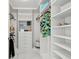 A walk-in closet with custom shelving, drawers and clothing racks at 1560 Gulf Blvd # 306, Clearwater Beach, FL 33767