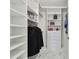 A walk-in closet with custom shelving, drawers, and ample storage space at 1560 Gulf Blvd # 306, Clearwater Beach, FL 33767