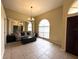 Bright living room featuring tile floors, a chandelier, and a large window that provides ample natural light at 18002 Kings Park Dr, Tampa, FL 33647
