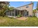 View of the home's back exterior with a screened-in patio and second story balcony at 19101 Marisa Ridge Pl, Tampa, FL 33647