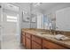 Bathroom featuring granite countertops, ample counter space, and a shower-tub combo for convenience at 19101 Marisa Ridge Pl, Tampa, FL 33647