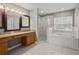 Bright bathroom featuring a walk-in shower, soaking tub, and double sink vanity with countertop space at 19101 Marisa Ridge Pl, Tampa, FL 33647
