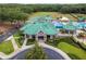 Aerial view of the community club with a green roof and tropical-themed recreational amenities at 19101 Marisa Ridge Pl, Tampa, FL 33647