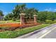 Community entrance featuring 'The Preserve' sign with colorful flower beds and lush landscaping at 19101 Marisa Ridge Pl, Tampa, FL 33647