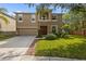 Beautiful two-story house featuring stone accents, a well-manicured lawn, and an attached two car garage at 19101 Marisa Ridge Pl, Tampa, FL 33647