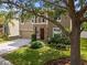 The home features beautiful landscaping, a stone entryway, and a two-car garage at 19101 Marisa Ridge Pl, Tampa, FL 33647