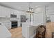 Modern kitchen featuring white cabinets, a large island with seating, and stainless steel appliances at 19101 Marisa Ridge Pl, Tampa, FL 33647