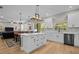 Spacious kitchen with white cabinets, stainless appliances, and a center island with seating at 19101 Marisa Ridge Pl, Tampa, FL 33647