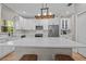 Bright kitchen with white cabinets, stainless appliances, and large center island at 19101 Marisa Ridge Pl, Tampa, FL 33647