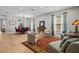 Open living room with hardwood floors, a large rug, neutral paint and a view to the dining area at 19101 Marisa Ridge Pl, Tampa, FL 33647