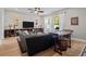 Comfortable living room with hardwood floors, ceiling fan, and large windows at 19101 Marisa Ridge Pl, Tampa, FL 33647