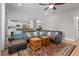 Spacious living area with hardwood floors, ceiling fan, and view of the kitchen at 19101 Marisa Ridge Pl, Tampa, FL 33647