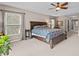 Light-filled main bedroom with tray ceiling, ceiling fan, and ensuite bathroom at 19101 Marisa Ridge Pl, Tampa, FL 33647
