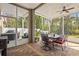Screened patio featuring a dining table and grill, creating an inviting outdoor living and dining space at 19101 Marisa Ridge Pl, Tampa, FL 33647