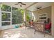 This covered and screened patio features ceiling fans and comfortable outdoor seating at 19101 Marisa Ridge Pl, Tampa, FL 33647