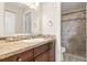 Bathroom vanity featuring a decorative backsplash, wood cabinet, granite countertops and framed mirror at 1913 Peppertree Dr, Oldsmar, FL 34677