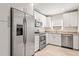 Updated kitchen featuring stainless steel appliances and sleek white cabinets at 1913 Peppertree Dr, Oldsmar, FL 34677