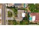 An aerial view of the home, showing the roof, landscaping, nearby pool, and driveway at 2001 Pinellas Point S Dr, St Petersburg, FL 33712
