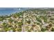 Nice aerial showcases neighborhood homes with mature trees near a body of water with some buildings in the background at 2001 Pinellas Point S Dr, St Petersburg, FL 33712