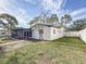 Home exterior shows a fenced yard and mature trees on a sunny day at 2001 Pinellas Point S Dr, St Petersburg, FL 33712