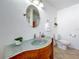 Bathroom featuring unique glass sink, vanity, modern fixtures and bright lighting at 2001 Pinellas Point S Dr, St Petersburg, FL 33712