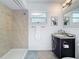 Bathroom features a tiled shower, updated vanity, and modern fixtures at 2001 Pinellas Point S Dr, St Petersburg, FL 33712