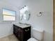 Charming bathroom features double sinks, granite countertops, and decorative mirrors at 2001 Pinellas Point S Dr, St Petersburg, FL 33712
