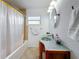 Bathroom featuring unique sink, vanity, mirror and bathtub with shower at 2001 Pinellas Point S Dr, St Petersburg, FL 33712