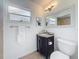 Updated bathroom with a vanity, granite countertop, and a shower with tile surround at 2001 Pinellas Point S Dr, St Petersburg, FL 33712