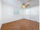 Bedroom with wood-look floors, a ceiling fan, and a double-door closet at 2001 Pinellas Point S Dr, St Petersburg, FL 33712