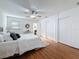 Bedroom features a ceiling fan, hardwood floors, and two closets at 2001 Pinellas Point S Dr, St Petersburg, FL 33712