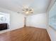 Bright bedroom with hardwood floors, a ceiling fan, and a ensuite bathroom at 2001 Pinellas Point S Dr, St Petersburg, FL 33712