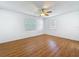 Bright bedroom with hardwood flooring, ceiling fan and two large windows at 2001 Pinellas Point S Dr, St Petersburg, FL 33712