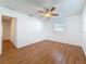 Bright bedroom with wood-look floors, ceiling fan and natural light from the window at 2001 Pinellas Point S Dr, St Petersburg, FL 33712