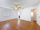 Bright bedroom features wood-look floors, a ceiling fan and natural light from the window at 2001 Pinellas Point S Dr, St Petersburg, FL 33712